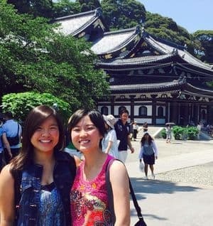 Two Japanese students in front of a building in Japan