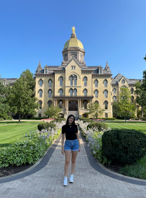 Yosibel Cabrera '26 in front of the Golden Dome.